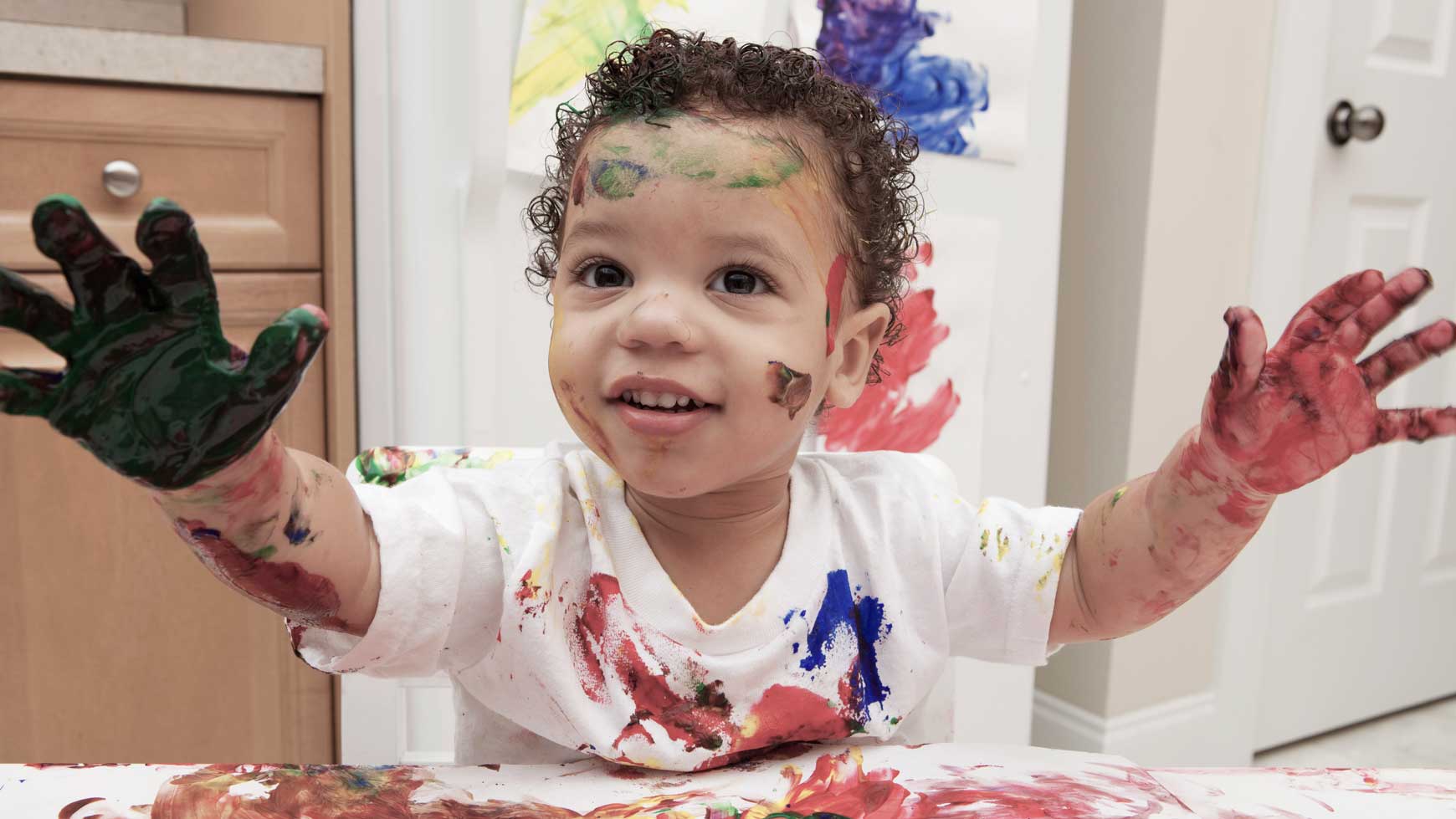 Child doing finger painting