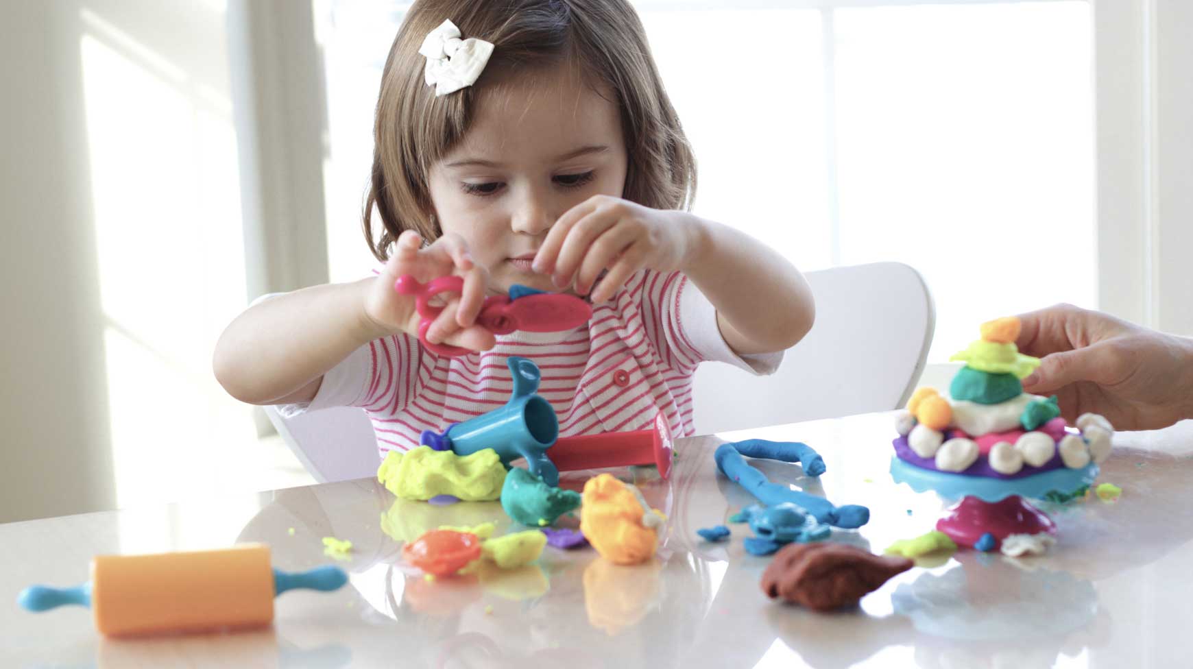 Child playing with play dough